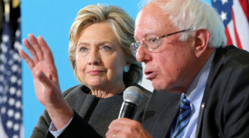 U.S. Democratic presidential nominee Hillary Clinton listens as U.S. Senator Bernie Sanders