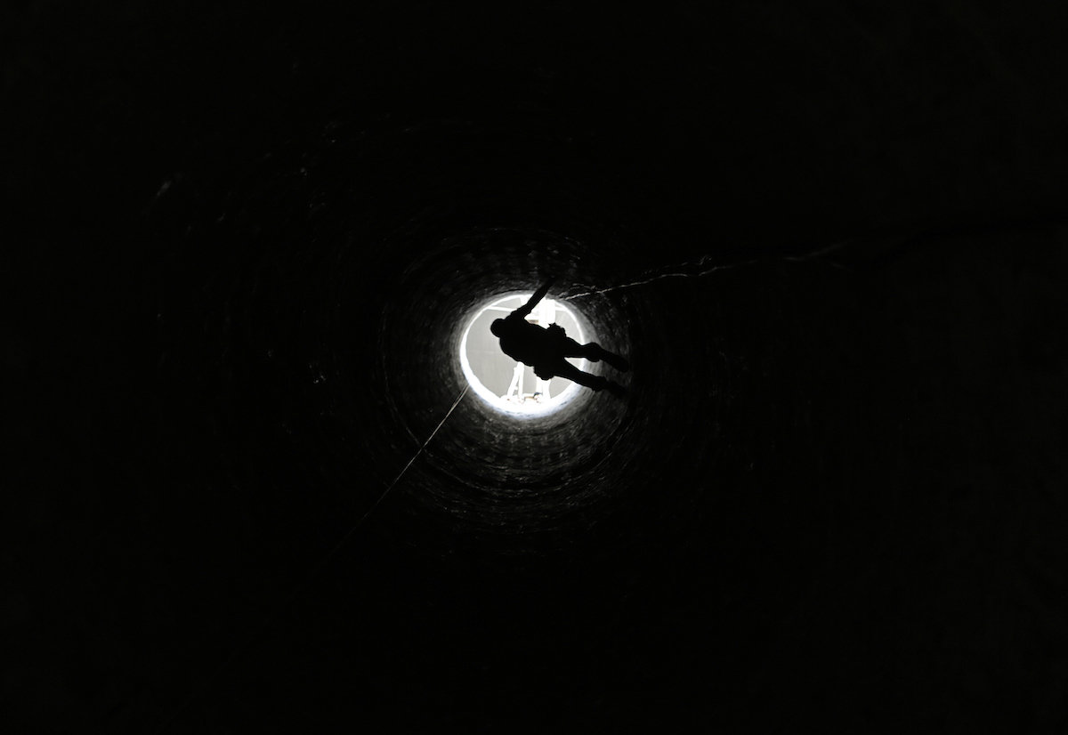 Palestinian man is lowered into a smuggling tunnel