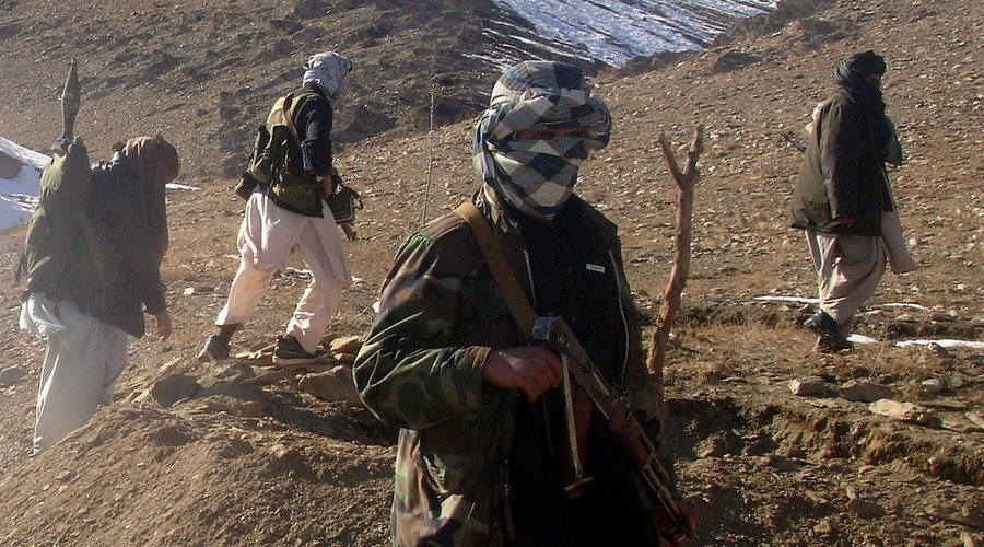 Taliban militants are seen with their weapons in an undisclosed location in Afghanistan