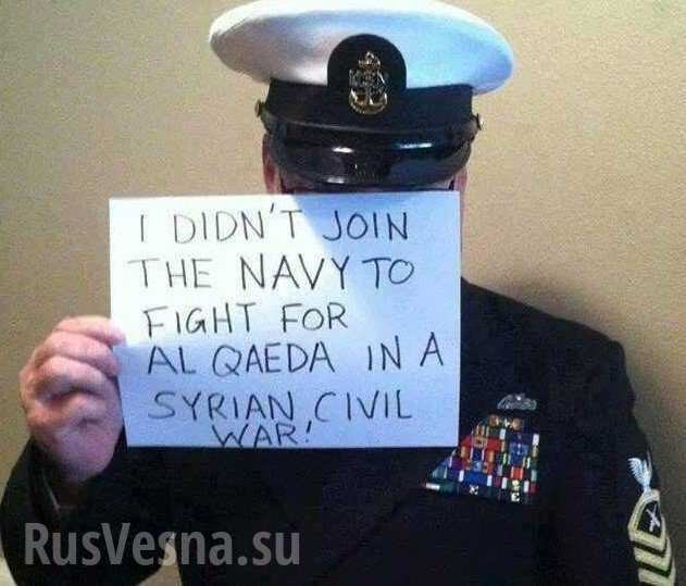 Photo of US navy person holding sign