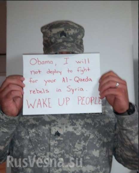 Click to enlarge US soldier holding sign