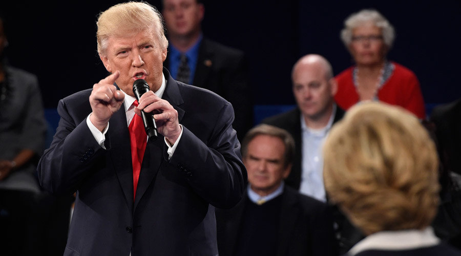 Republican U.S. presidential nominee Donald Trump speaks as Democratic U.S. presidential nominee Hillary Clinton (R) listens during their presidential town hall debate at Washington University in St. Louis, Missouri, U.S., October 9, 2016. Saul Loeb/Reute