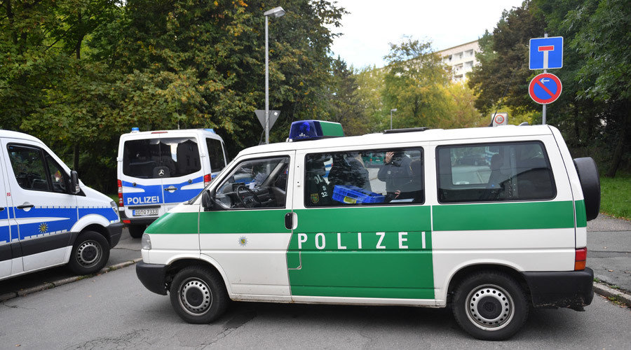 Click to enlarge Police cars stand near a residential area in Chemnitz, eastern Germany, where German police commandos hunting a fugitive Syrian bomb plot suspect raided a flat on October 9, 2016. Hendrik Schmidt/AFP
