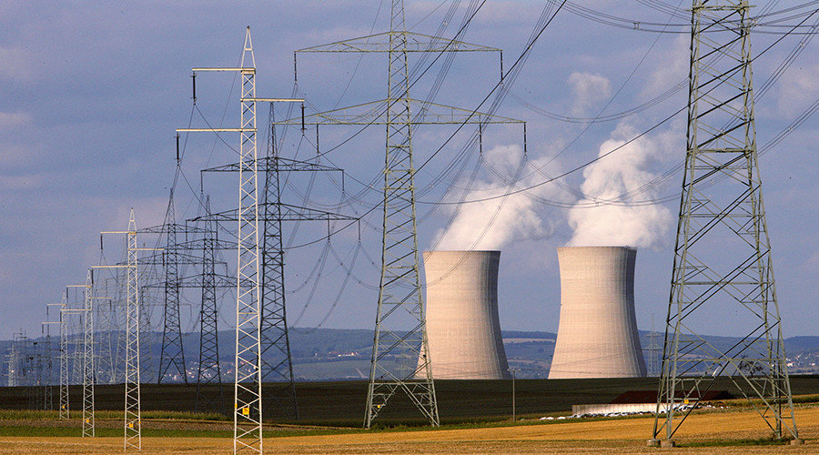 Pylons stand in front of the cooling towers of the Grafenrheinfeld nuclear power station in northern Bavaria 