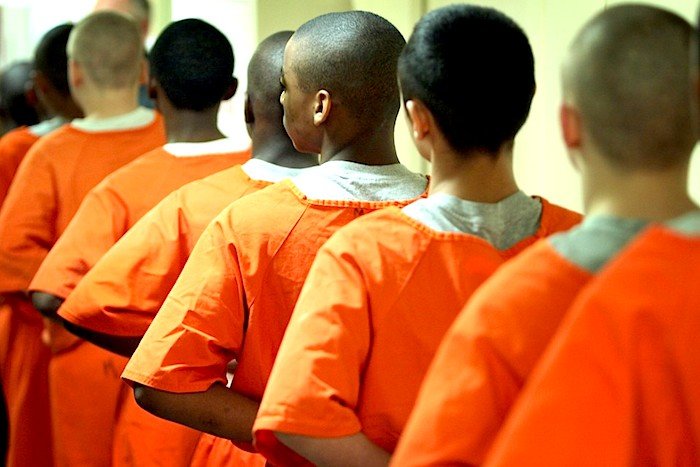 boy prisoners in orange