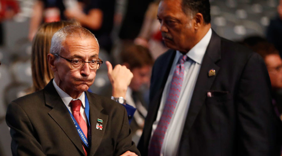 John Podesta (L) stands next to Rev. Jesse Jackson