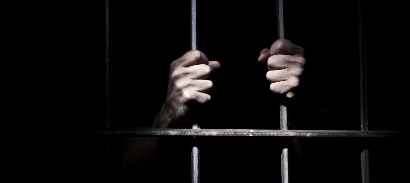 Prisoner's hands in a cell