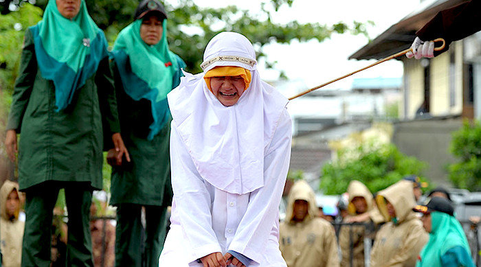 Click to enlarge woman being caned