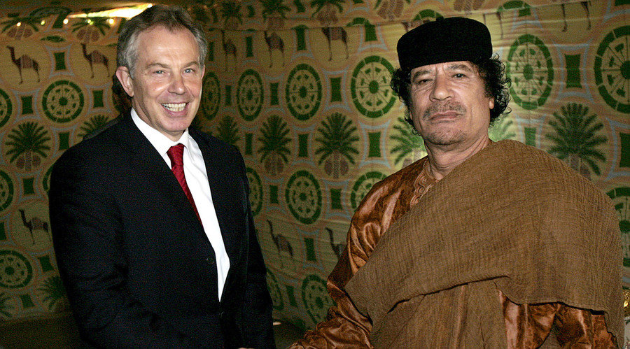 Britain's Prime Minister Tony Blair (L) shakes hands with Libyan leader Muammar Gaddafi 