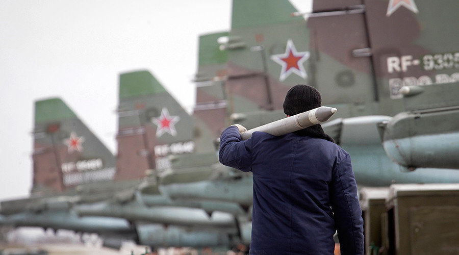 A serviceman carries missile