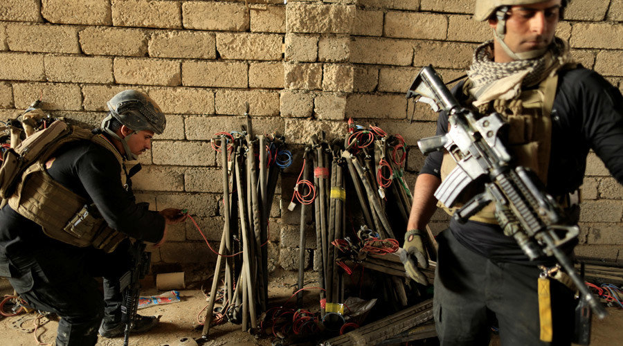 Click to enlarge Iraqi special forces soldier checks detonation devices