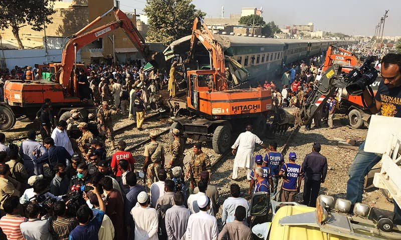 Rescuers workers use heavy machinery on the car of a train