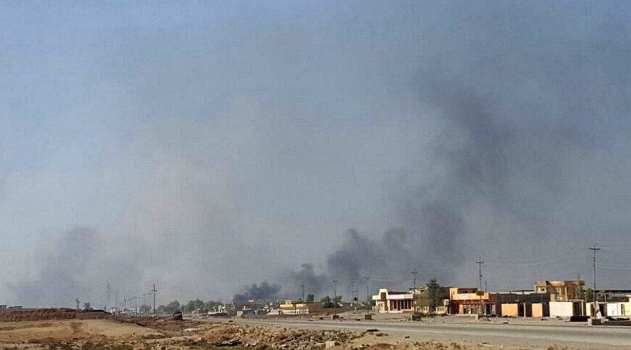 Smoke rises over Karama district in Mosul where Iraqi troops are fighting Islamic State
