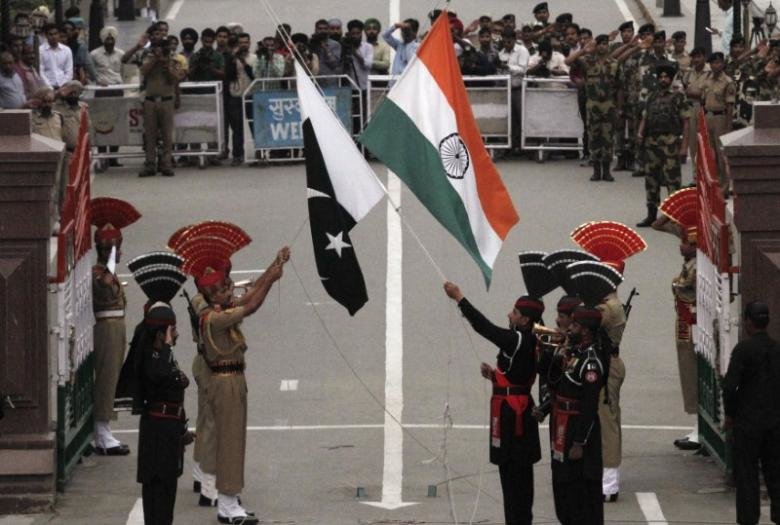 Pakistani rangers (wearing black uniforms) and Indian Border Security Force (BSF) officers