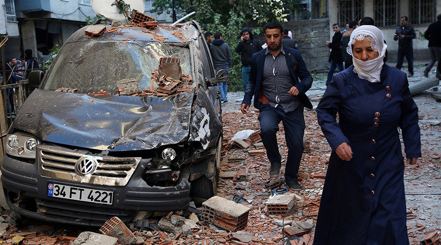 Click to enlarge People walk past a damaged car after a blast in the Kurdish-dominated southeastern city of Diyarbakir, Turkey, November 4, 2016