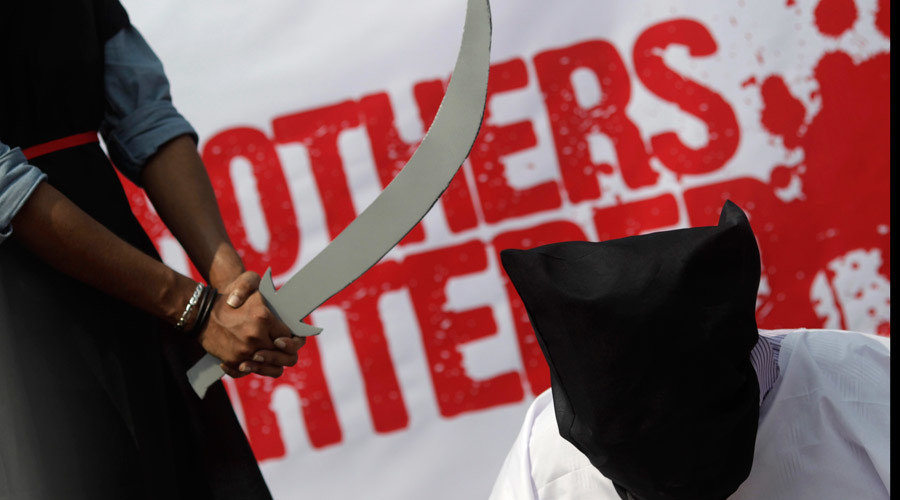 Click to enlarge Protester holding fake sword beheading