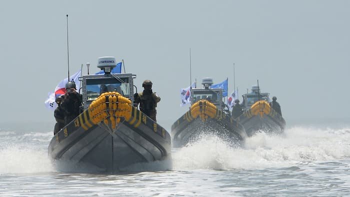 Click to enlarge South Korean military vessels patrol the waters for illegal Chinese fishing activity around Ganghwa Island, in the country's northwest, on June 10.