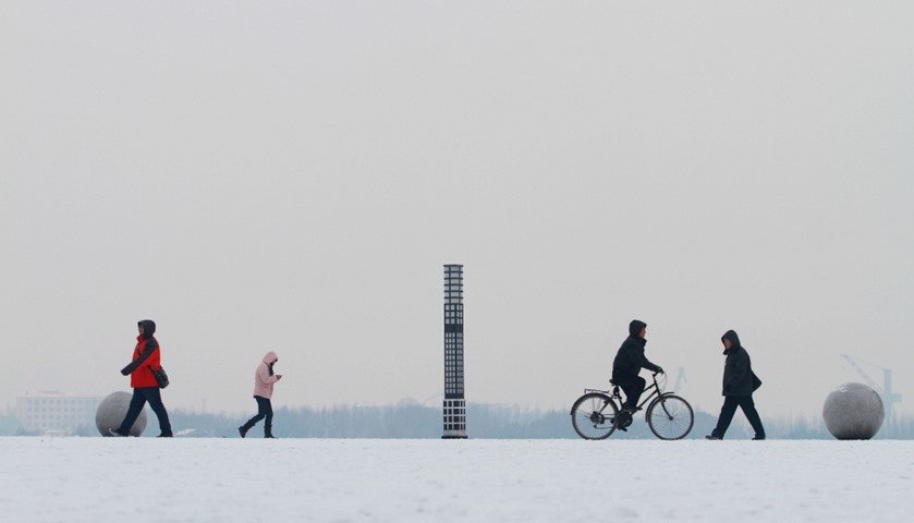  People walk along the Songhua River in snow in Harbin, Heilongjiang province, China