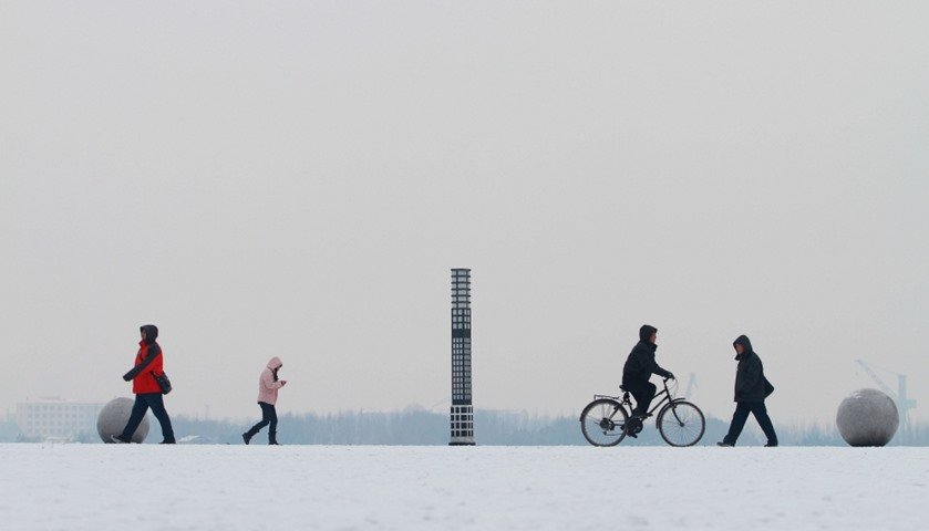Click to enlarge People walk along the Songhua River in snow in Harbin, Heilongjiang province, China