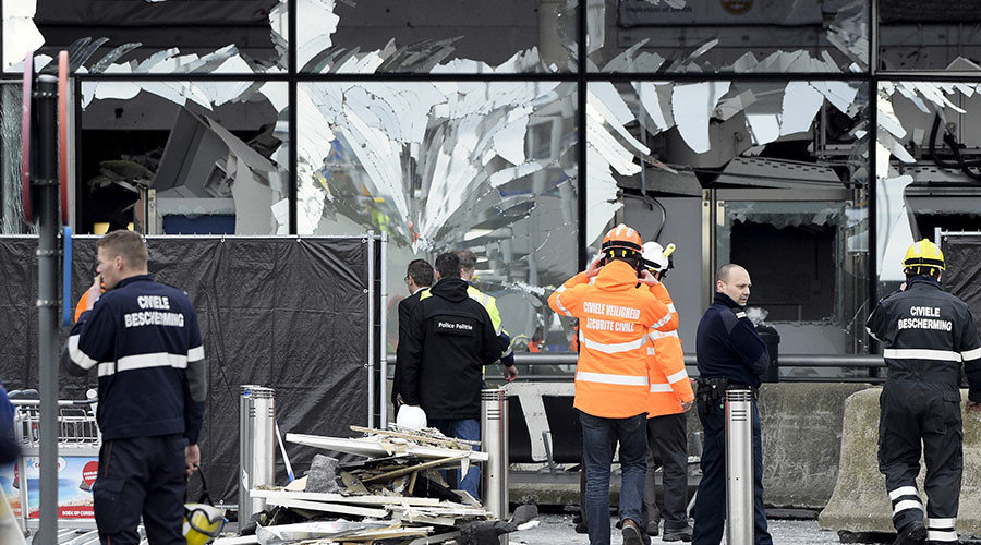 Broken windows of the terminal at Brussels national airport are seen during a ceremony following bomb attacks in Brussels metro 