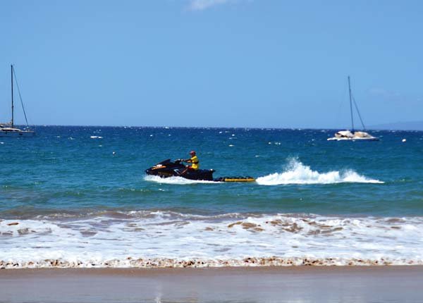Click to enlarge A Maui County ocean safety officer patrols the coastline near Kamaole Beach Park I, where a woman was the victim of an apparent shark attack Monday morning. The 58-year-old woman was in stable condition at Maui Memorial Medical Center after the attack.