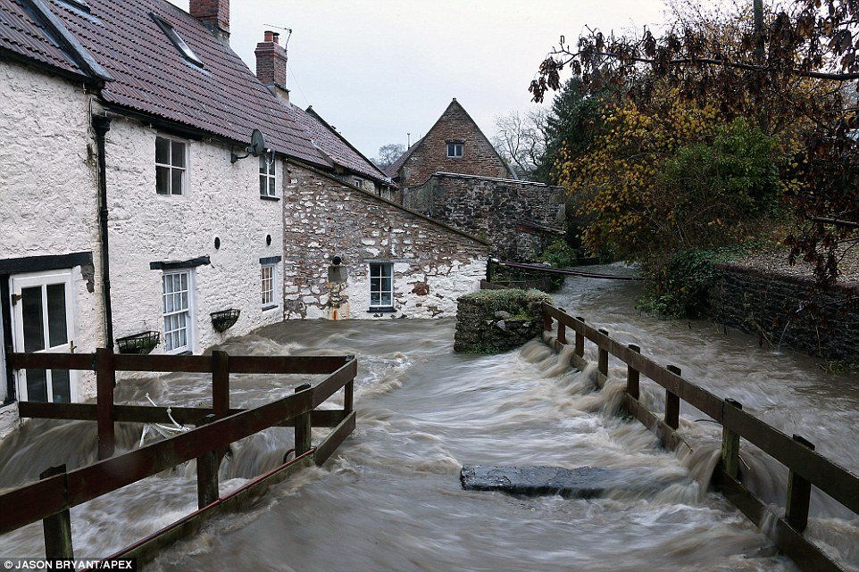 A house is surrounded by flood waters at Croscombe in Somerset following torrential rain in the south west of England