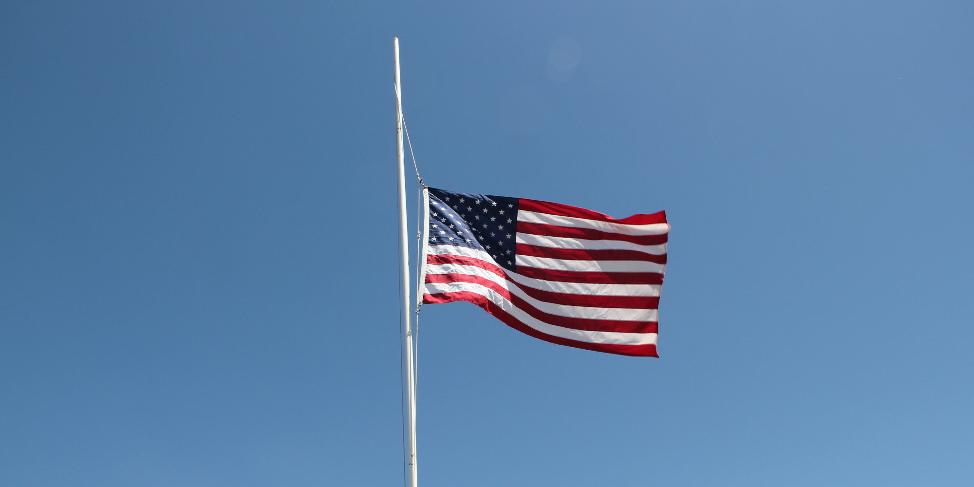 US flag at half staff, large