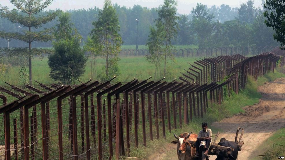 Click to enlarge An Indian farmer on a cart passes along the line of control in Kashmir