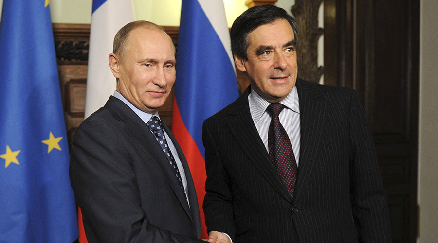 Russia's Prime Minister Vladimir Putin (L) and his French counterpart Francois Fillon