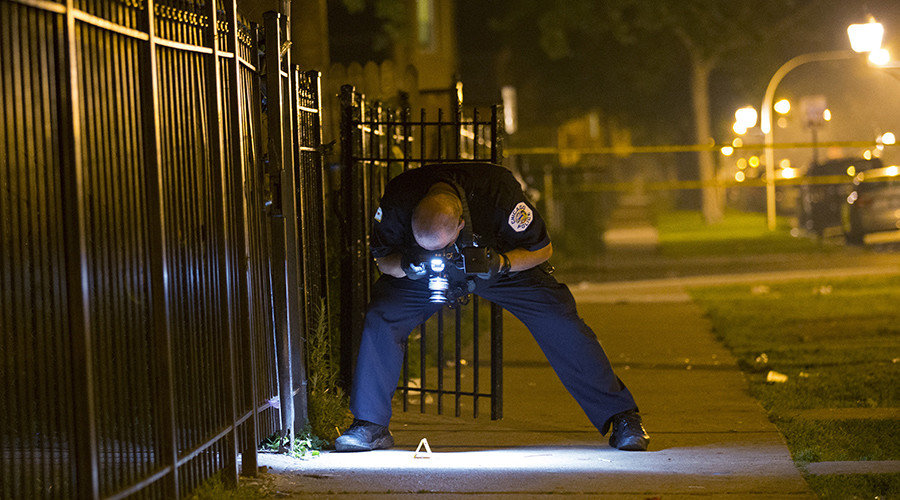 Click to enlarge police photographing evidence
