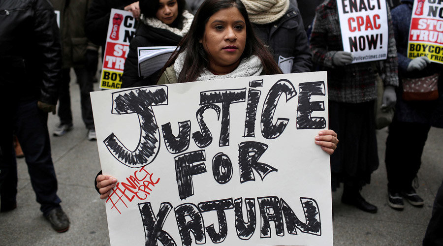 A demonstrator holds a sign as protesters try to disrupt Black Friday shopping in Chicago