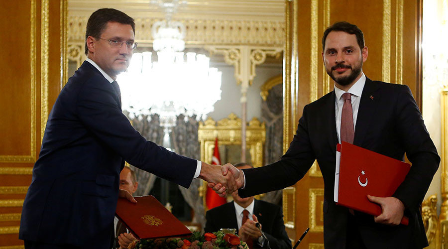 Russian Energy Minister Alexander Novak (L) shakes hands with his Turkish counterpart Berat Albayrak