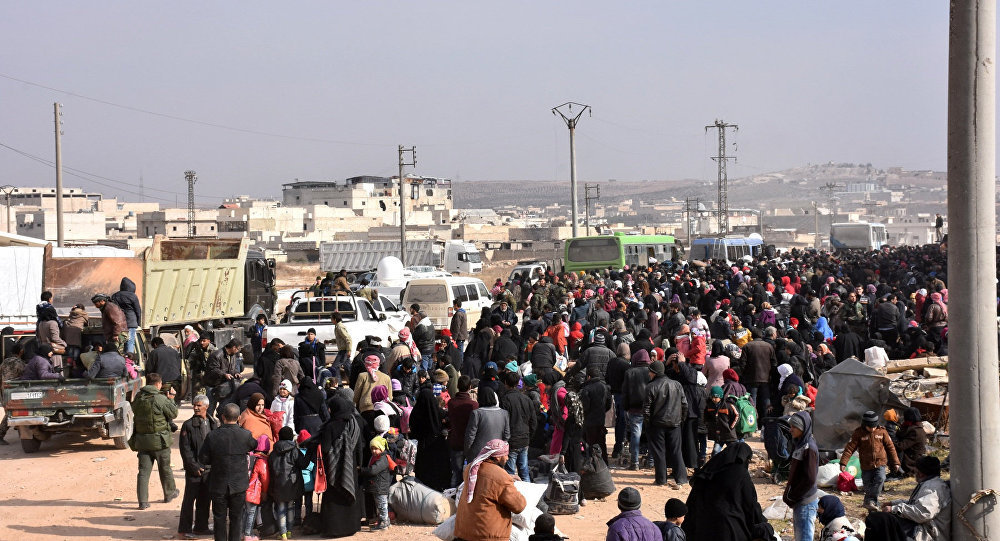 Syrians that evacuated the eastern district of Aleppo gather to board buses, in a government held area in Aleppo,Syria in this handout picture provided by SANA on November 29, 2016