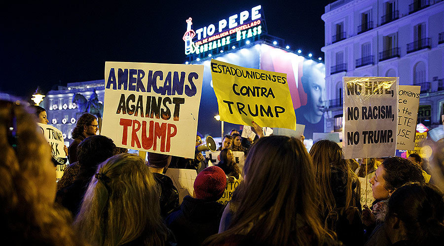 Click to enlarge Demonstrators hold up signs during a protest against U.S. President-elect Donald