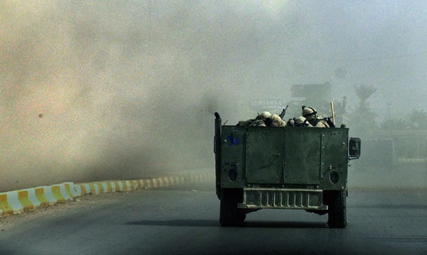 US Marines drive through smoke and dust from a roadside bomb in Ramadi, Iraq