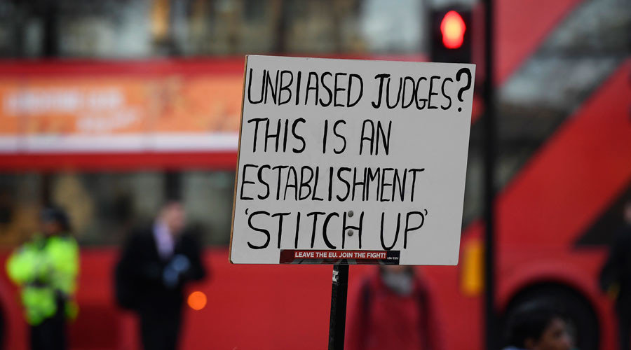 protester holds up a placard outside the UK Supreme Court