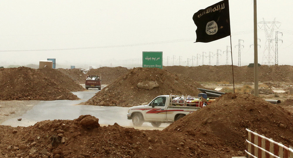 Islamic State militants passing a checkpoint bearing the group's trademark black flag in the village of Maryam Begg in Kirkuk, 290 kilometers (180 miles) north of Baghdad,Iraq
