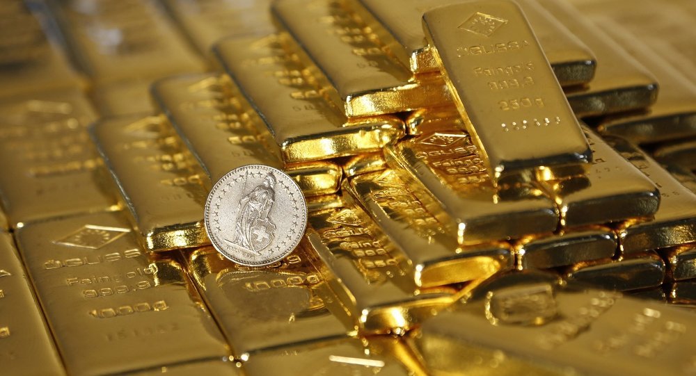 gold bars and swiss franc coin