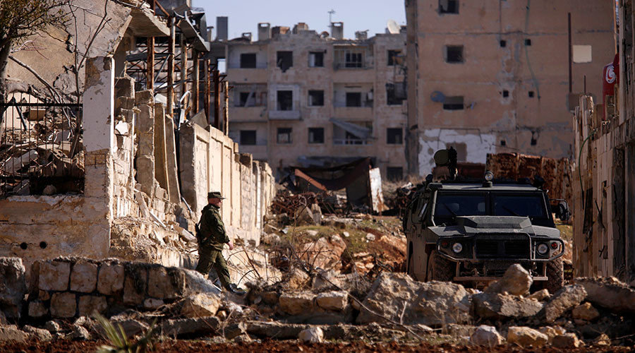 A Russian soldier walks to a military vehicle in goverment controlled Hanono housing district in Aleppo, Syria December 4, 2016