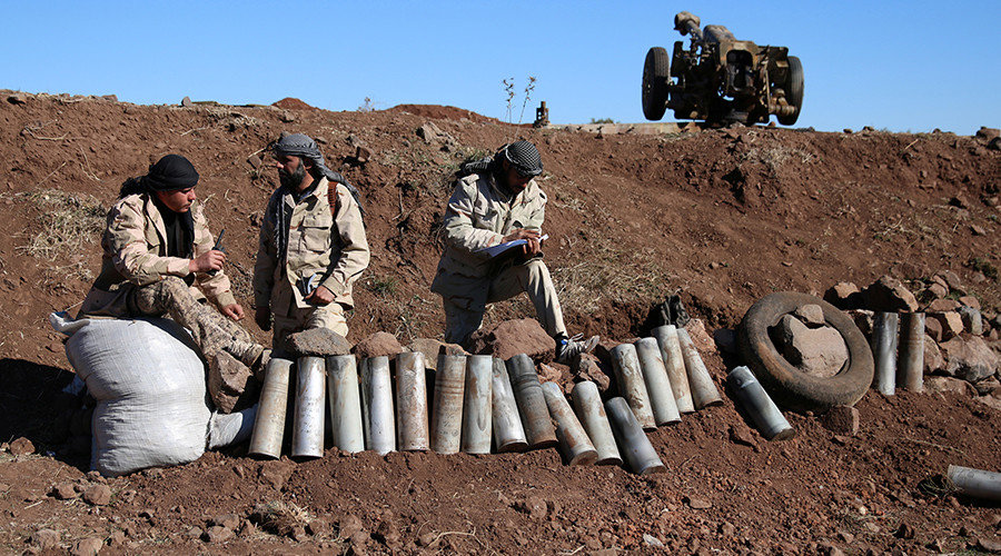 Rebel fighters stand near empty rockets in Syria