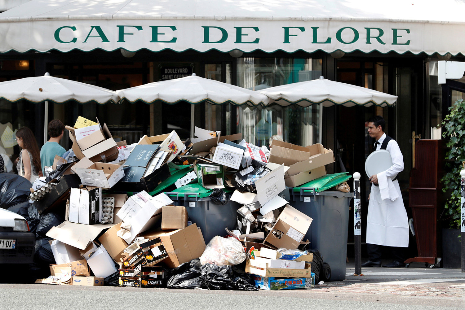 Click to enlarge pile of trash bags in front of the Cafe de Flore in Paris