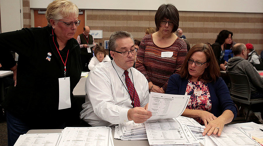 Click to enlarge Oakland County clerks count election ballots during a recount of presidential ballots in Waterford Township, Michigan December 5, 2016.