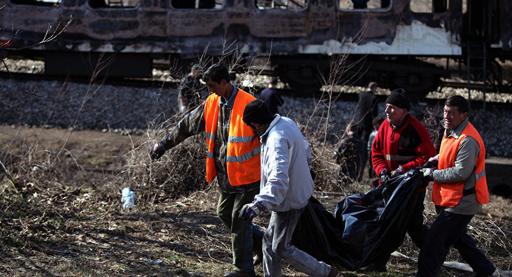 Bulgarian health care officers help to transfer the bodies from the burnt train