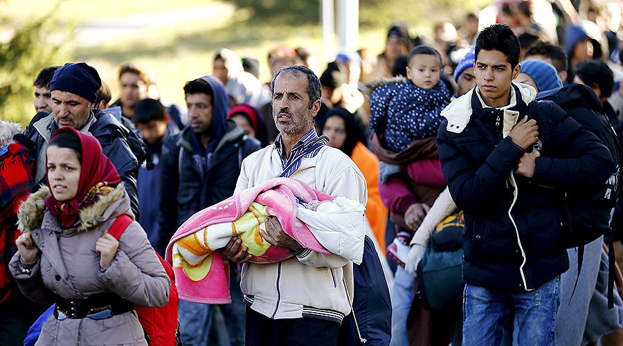 Migrants walk towards the Austrian border