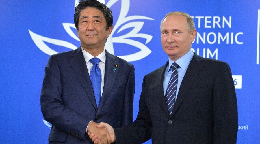 Click to enlarge putin abe handshake