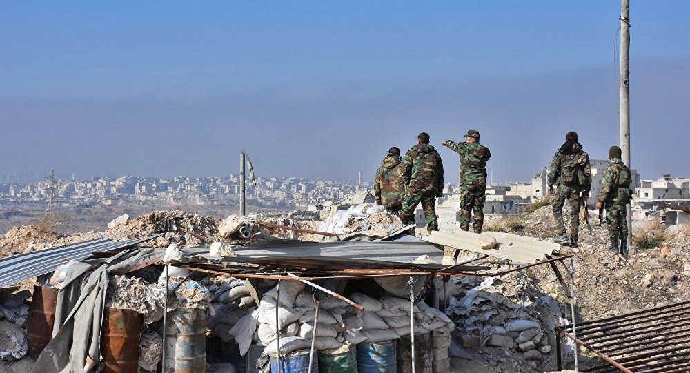 Syrian pro-government forces patrol Aleppo's Sheikh Saeed, on December 12, 2016, after troops retook the area from rebel fighters