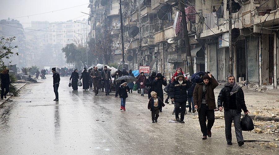 Syrians leave a rebel-held area of Aleppo towards the government-held side on December 13, 2016 