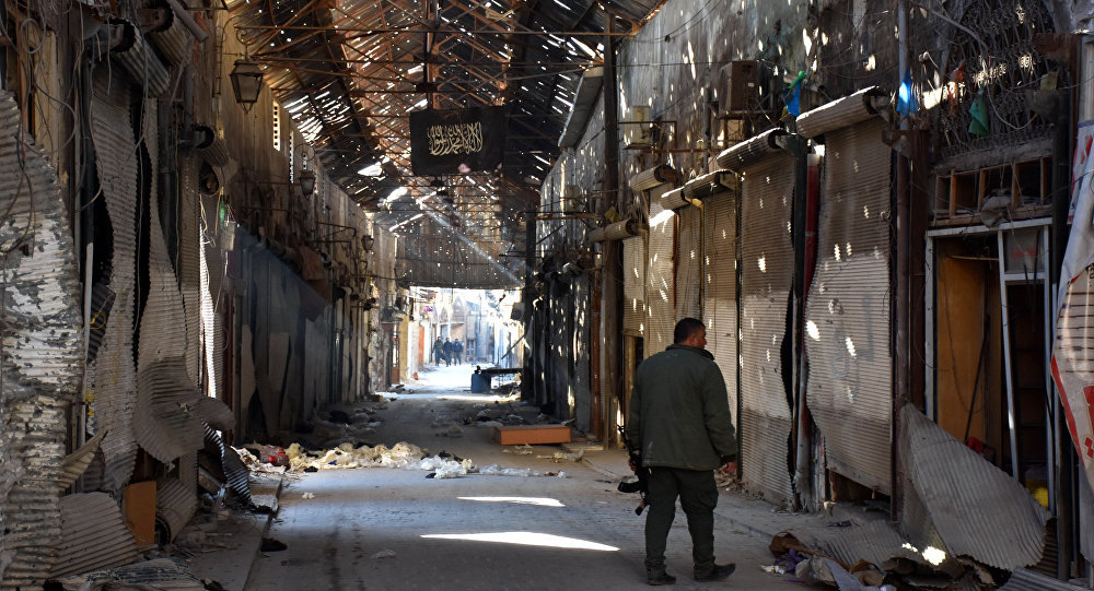 A Syarian Army soldier walks past closed shops in the Bab al-Nasr district of Aleppo's Old City on December 9, 2016