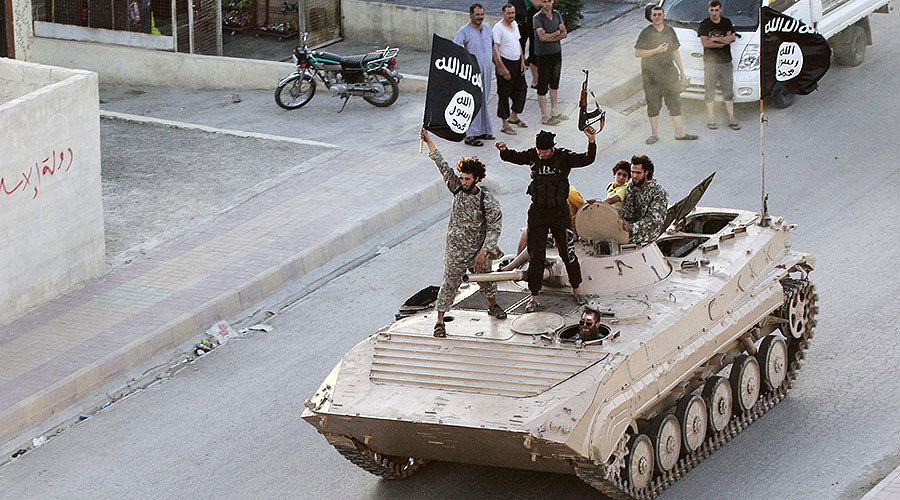 Militant Islamist fighters take part in a military parade along the streets of northern Raqqa province