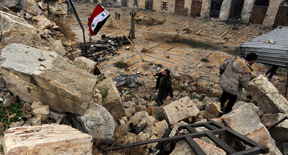 A member of forces loyal to Syria's President Bashar al-Assad attempts to errect the Syrian national flag inside the Umayyad mosque, in the government-controlled area of Aleppo, during a media tour, Syria December 13, 2016